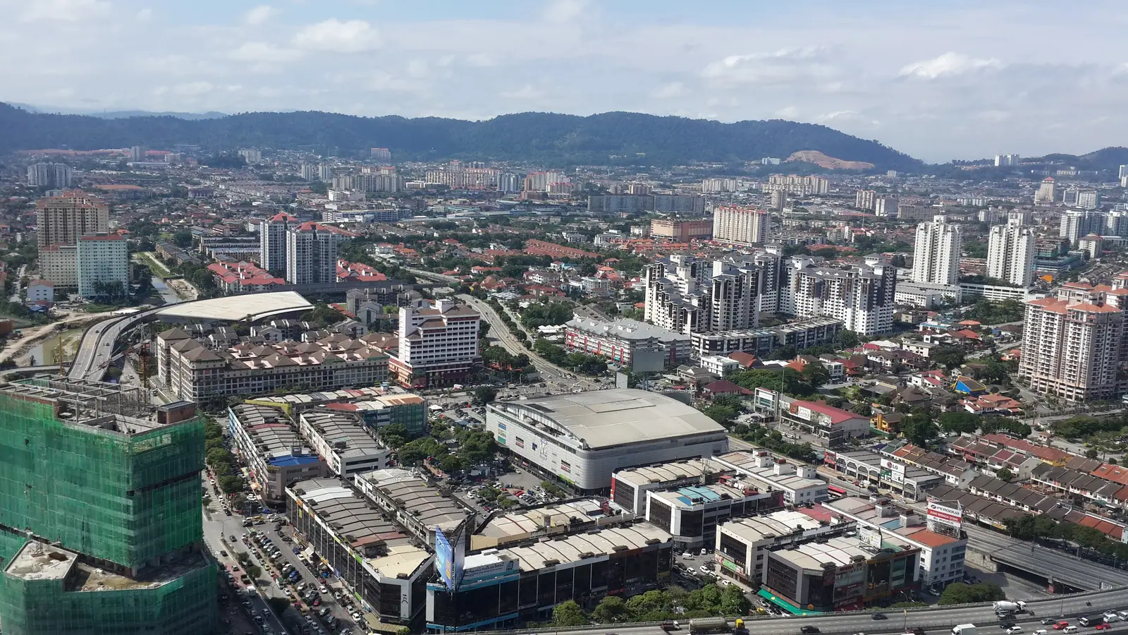 Aerial view of Ampang Jaya with hills behind, home to karaoke Ampang venues