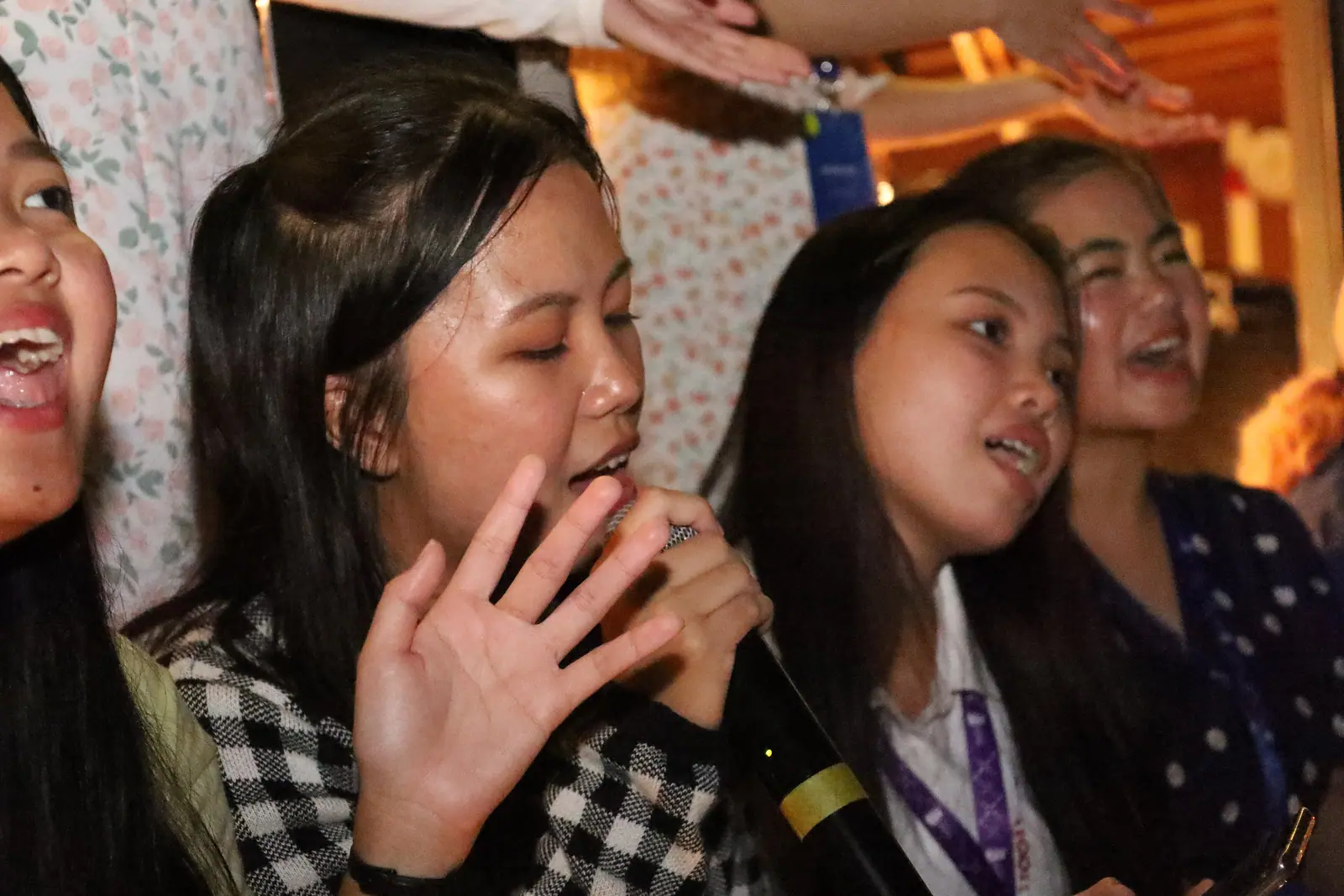 Friends singing together, the kind of scene a karaoke birthday party in KL is planned around (stock photo, not a specific venue)